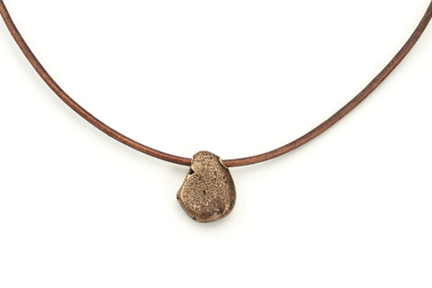 Manzanita... Bronze beach stone on leather cord with bronze clasp